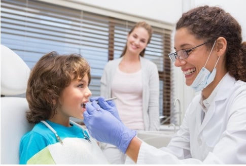 Family Dentist Manassas VA | Dentist examining little boy's teeth.