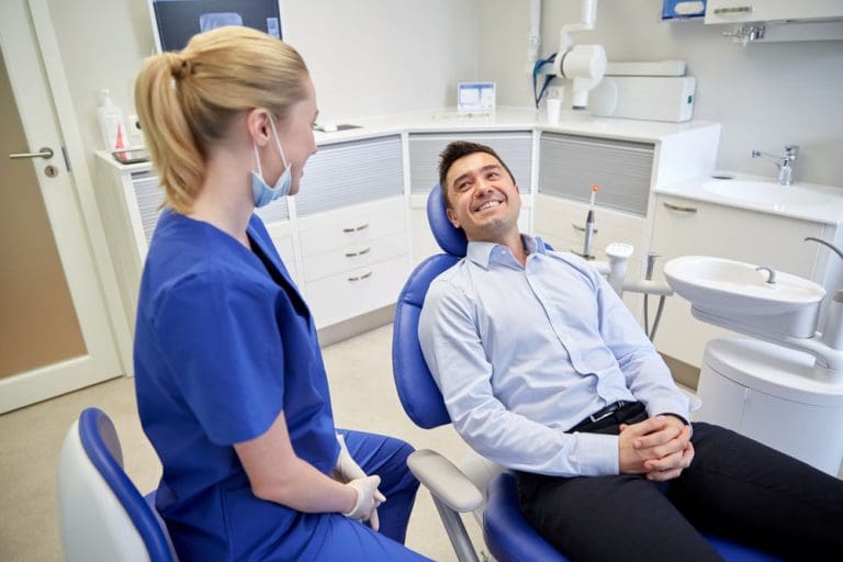 Tooth Infection | Dentist speaking to patient.