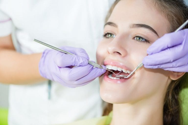 Dental Exam | Patient receiving dental cleaning.