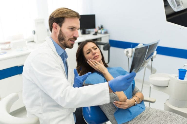 Tooth Pain Treatment | Dentist showing patient an x-ray.