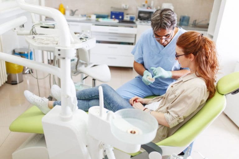 Manassas Dental Office | Dentist showing patient something.