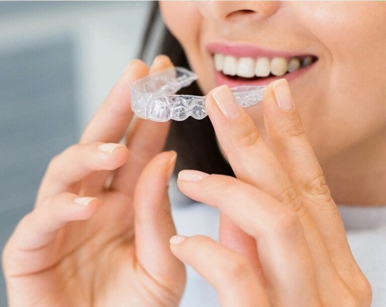 woman putting on invisalign