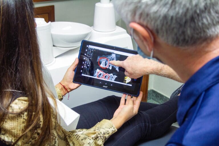 doctor showing teeth xray to patient